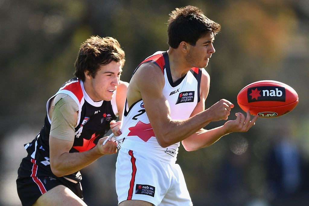 MELBOURNE, AUSTRALIA - SEPTEMBER 30: Ben Jarman of the Michael O'Loughlin Under 18's handballs whilst being tackled by Andrew McGrath of the Chris Judd Under 18's during the NAB All Stars Under 18 match at Punt Road Oval on September 30, 2016 in Melbourne, Australia. (Photo by Quinn Rooney/Getty Images)